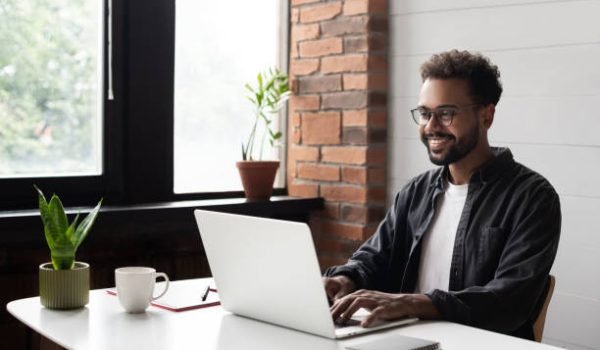 Businessman using laptop computer in office. Student studying online. Entrepreneur, creative occupation, work from home, freelance, online learning, studying concept. Distance education